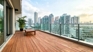 Modern balcony decking in Singapore with timber flooring and city skyline views